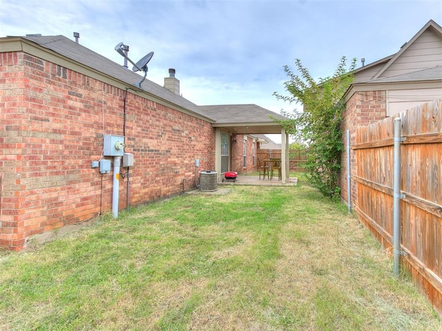 view of yard featuring central air condition unit and a patio