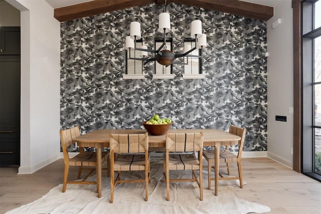 dining area featuring light wood-type flooring and beamed ceiling