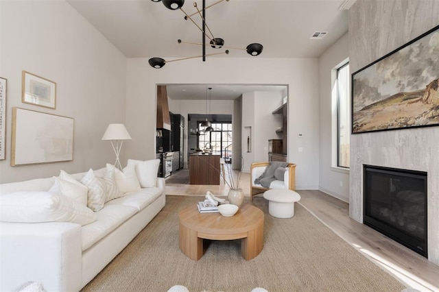 living room featuring light hardwood / wood-style flooring and a fireplace