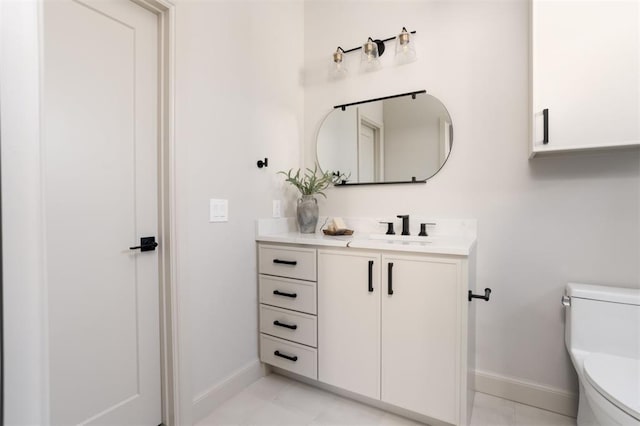 bathroom featuring toilet, tile patterned flooring, and vanity