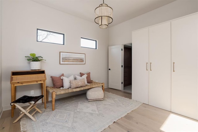 living area with a chandelier and light wood-type flooring