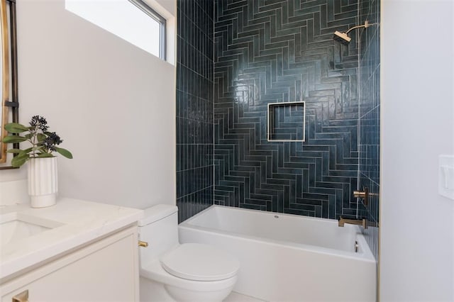 full bathroom featuring toilet, tiled shower / bath, and vanity