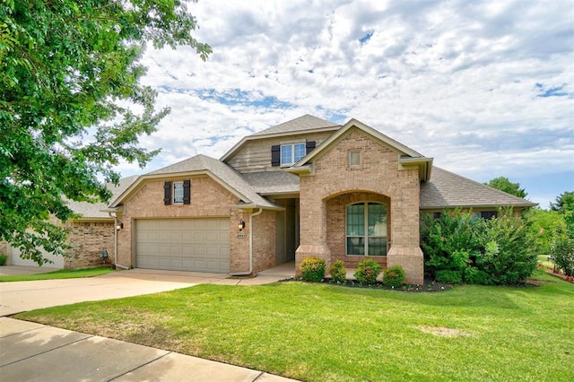 view of front of property featuring a garage and a front lawn