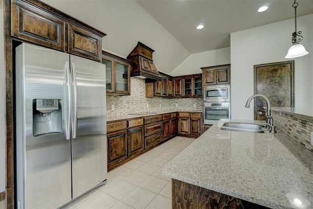 kitchen featuring tasteful backsplash, sink, decorative light fixtures, and appliances with stainless steel finishes