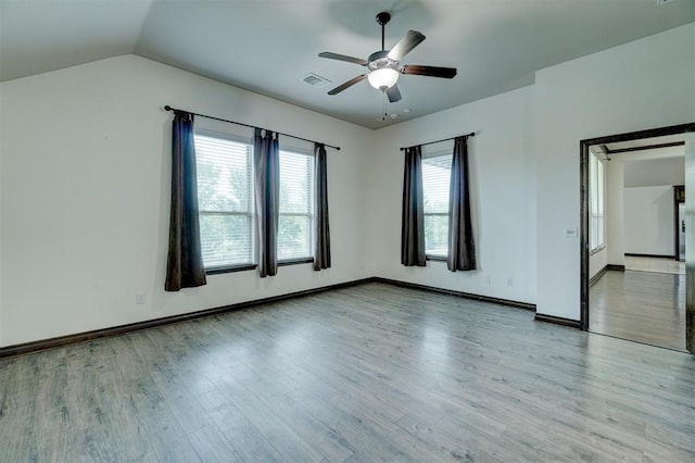 unfurnished room with ceiling fan, lofted ceiling, and light hardwood / wood-style flooring