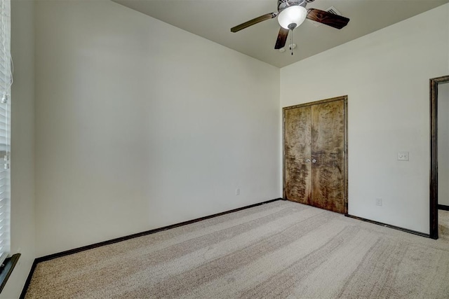 unfurnished bedroom with light carpet and ceiling fan