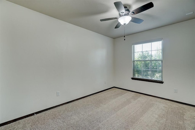 empty room featuring light carpet and ceiling fan