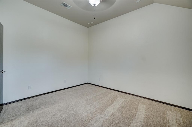 carpeted spare room with ceiling fan and lofted ceiling