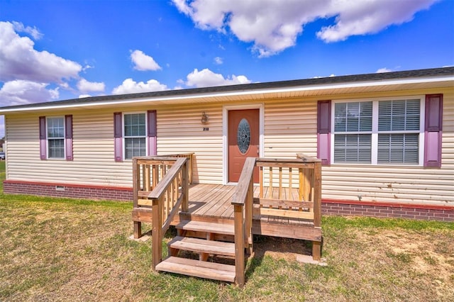 view of front of property with a front yard and a deck