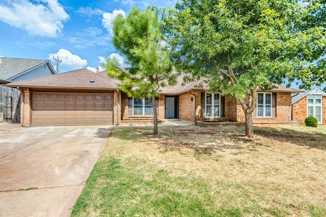 ranch-style house featuring a front lawn and a garage