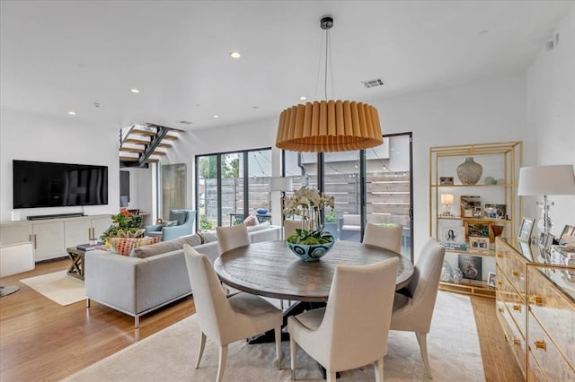 dining space with light hardwood / wood-style flooring