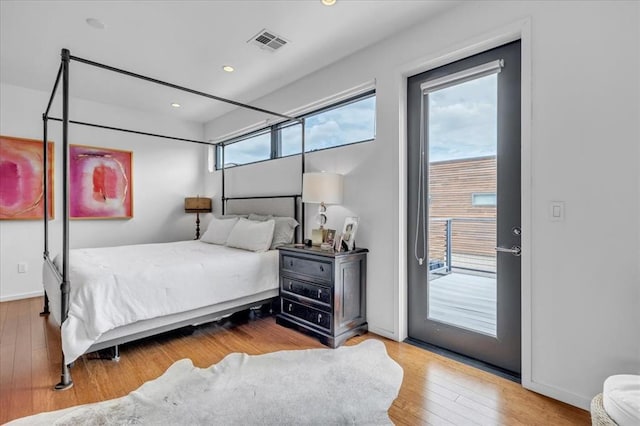 bedroom featuring access to outside and hardwood / wood-style flooring