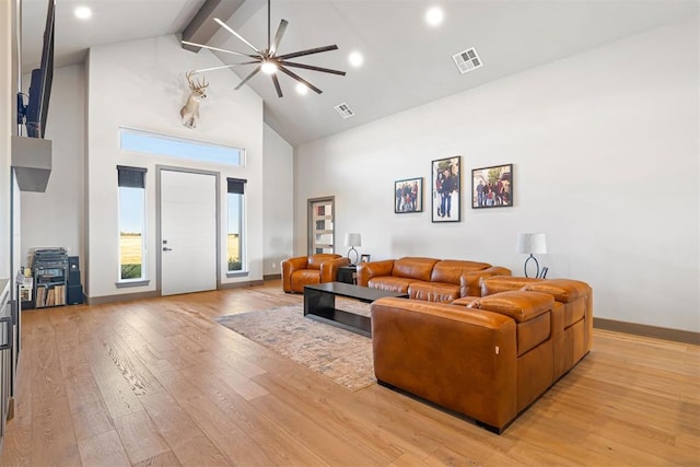 living room with beamed ceiling, high vaulted ceiling, light hardwood / wood-style flooring, and ceiling fan