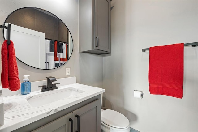 bathroom with vanity, toilet, and walk in shower