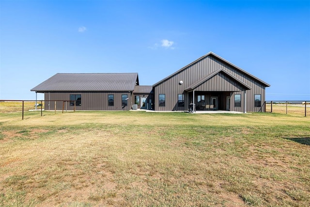 back of property with a lawn and an outbuilding