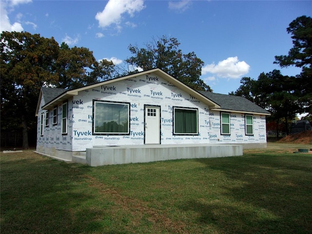 view of side of home with a yard