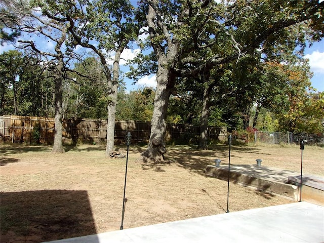 33322 Hardesty Rd, Shawnee, OK 74801 - fenced backyard with view of wooded area