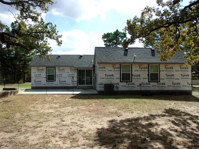 33322 Hardesty Rd, Shawnee, OK 74801 - rear view of house with a shingled roof, a patio area, and a lawn