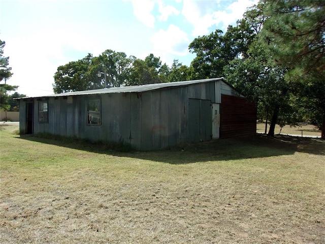 view of outdoor structure featuring a lawn