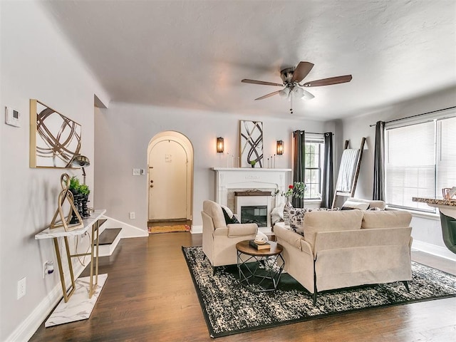 living room featuring dark hardwood / wood-style floors and ceiling fan