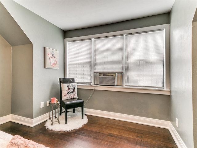 living area featuring dark hardwood / wood-style floors and cooling unit