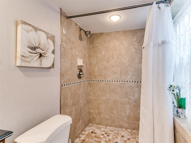 bathroom with curtained shower and toilet