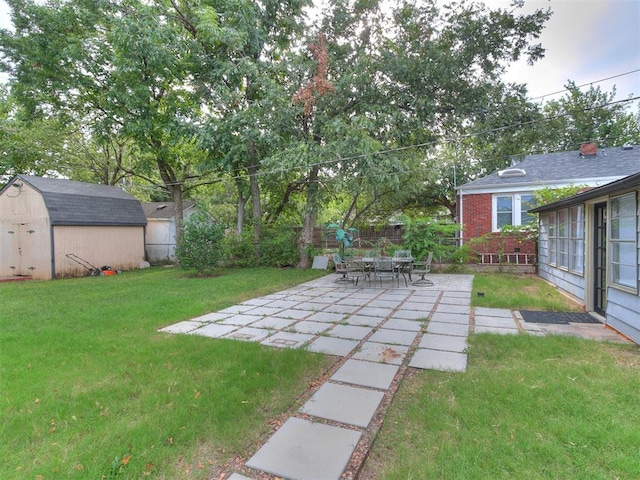 view of yard with a patio and a storage unit