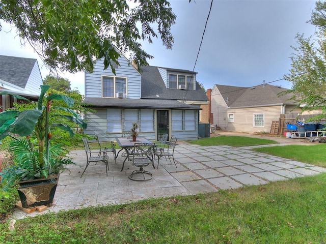 rear view of house with a yard and a patio