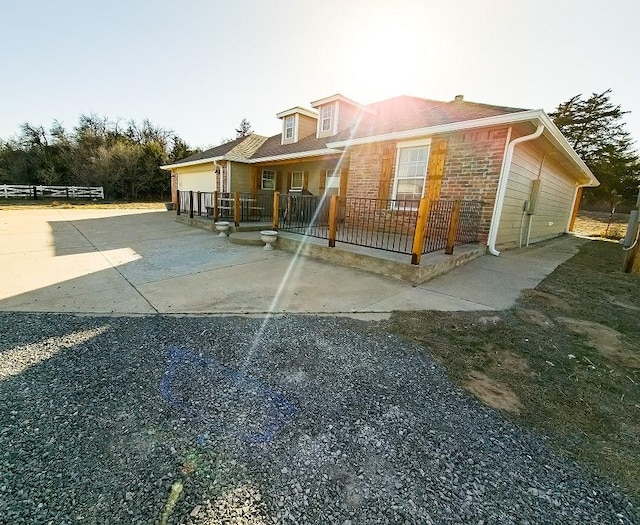 back of property with covered porch