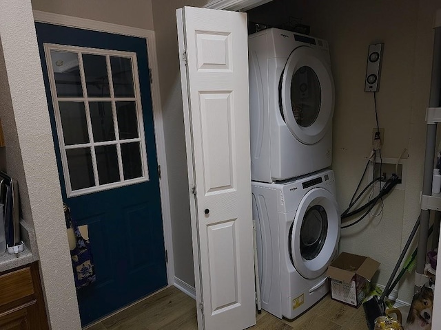 washroom featuring stacked washer / dryer and hardwood / wood-style floors