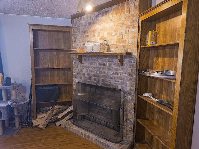 room details featuring a fireplace, hardwood / wood-style floors, and a textured ceiling