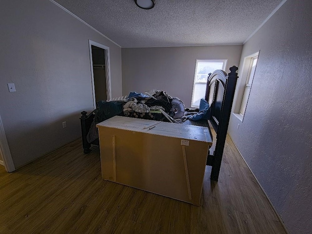 bedroom featuring hardwood / wood-style floors and a textured ceiling