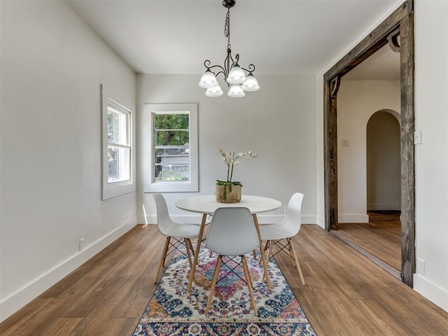 dining room featuring an inviting chandelier and hardwood / wood-style flooring