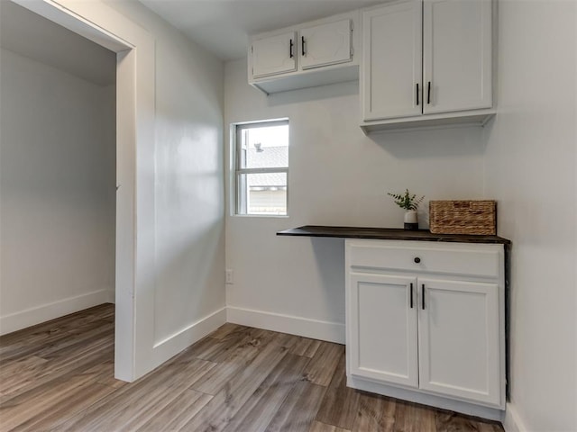 kitchen featuring white cabinets and light wood-type flooring