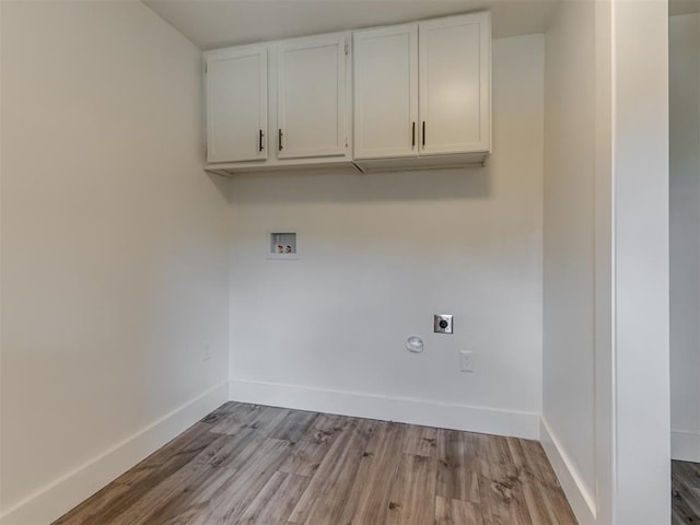 laundry area featuring cabinets, washer hookup, hookup for an electric dryer, and light hardwood / wood-style floors