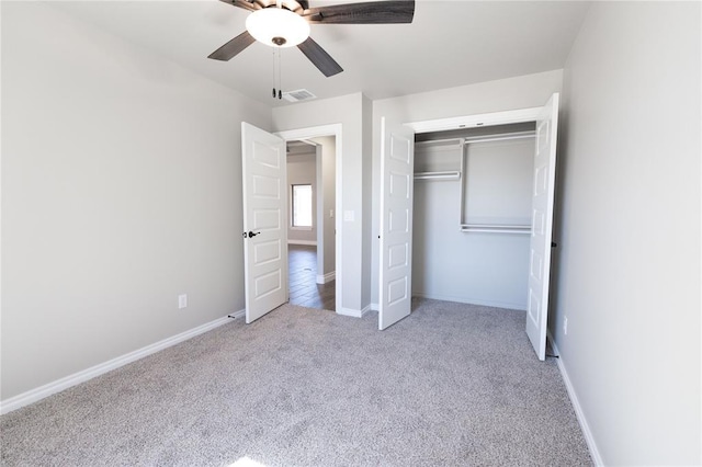 unfurnished bedroom with a closet, carpet flooring, visible vents, and baseboards