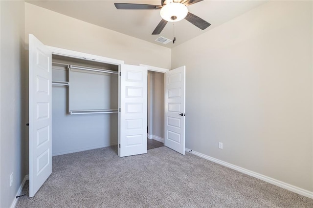 unfurnished bedroom with a closet, visible vents, a ceiling fan, carpet flooring, and baseboards