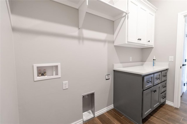 laundry room with baseboards, washer hookup, cabinet space, and wood tiled floor