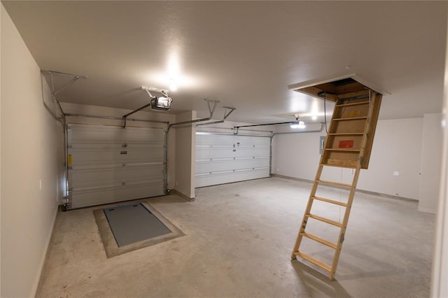 garage with a garage door opener and baseboards