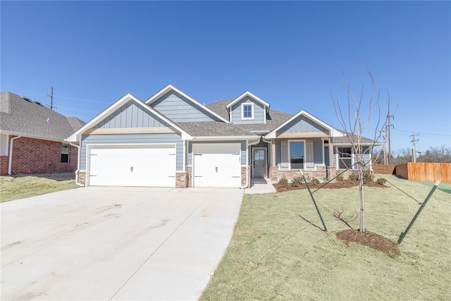 craftsman inspired home featuring driveway, an attached garage, fence, a front lawn, and board and batten siding