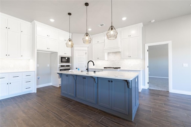 kitchen featuring white cabinetry, visible vents, built in microwave, and oven