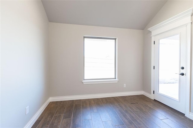 unfurnished room featuring lofted ceiling, baseboards, and dark wood finished floors