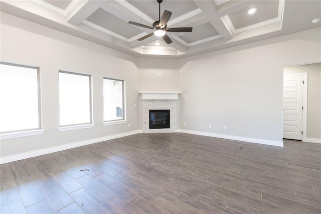 unfurnished living room with a healthy amount of sunlight, dark wood finished floors, and a ceiling fan