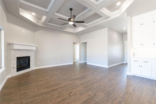 unfurnished living room with dark wood finished floors, a fireplace, ceiling fan, and baseboards