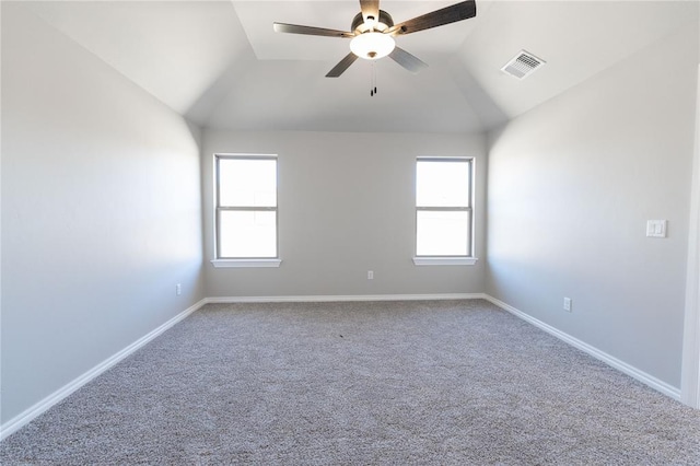 carpeted empty room with lofted ceiling, visible vents, plenty of natural light, and baseboards