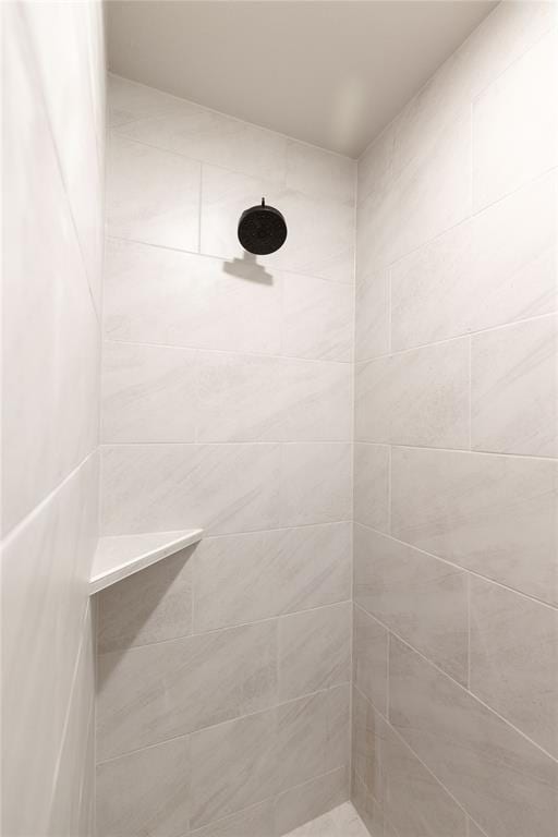 bathroom with tiled shower