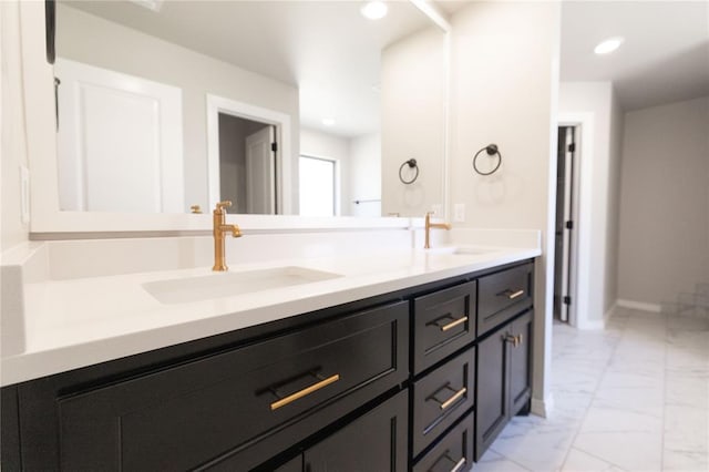 full bath with marble finish floor, a sink, and recessed lighting