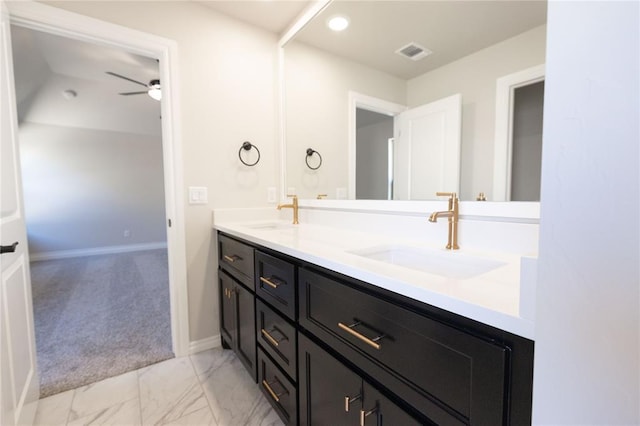 bathroom featuring marble finish floor, visible vents, a sink, and double vanity