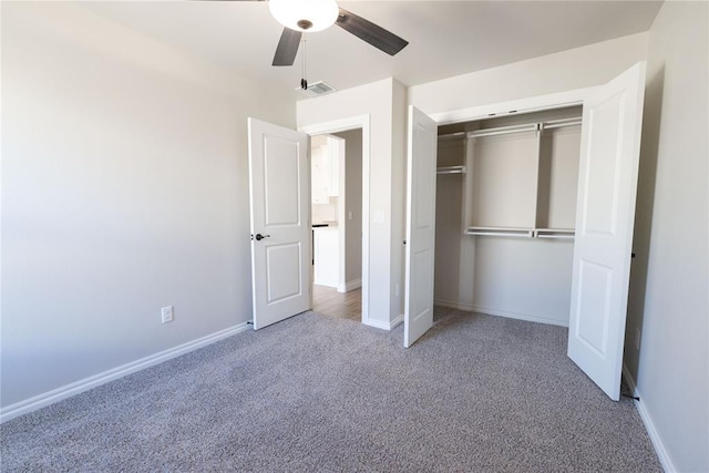 unfurnished bedroom with carpet floors, a closet, visible vents, a ceiling fan, and baseboards