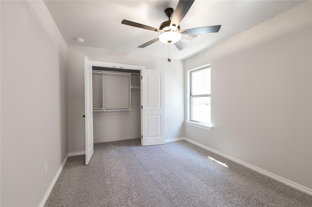 unfurnished bedroom with a closet, carpet flooring, ceiling fan, and baseboards